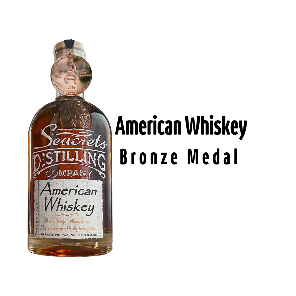 Bottle of Seacrets American Whiskey with a bronze metal
